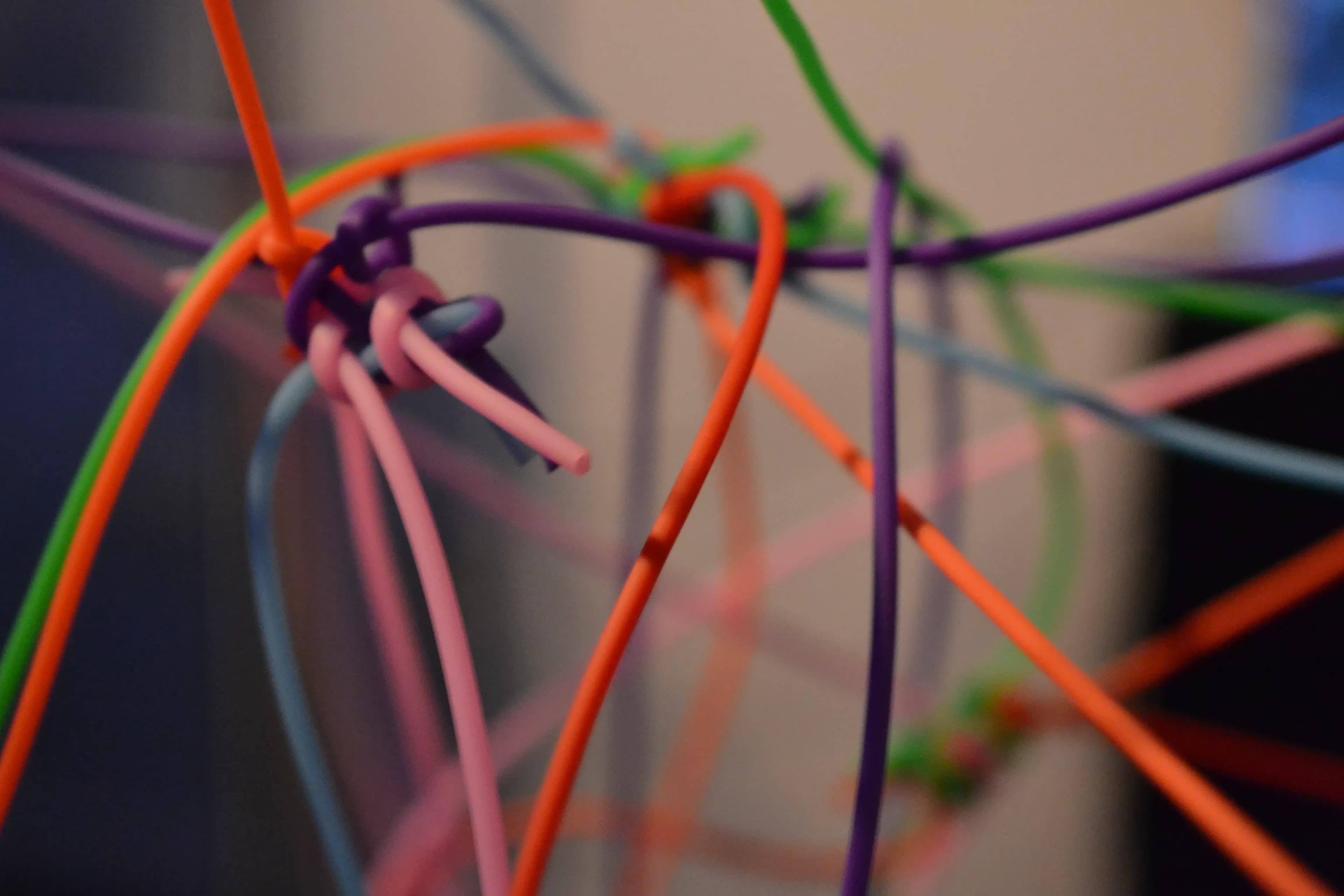 Macro detail of threads knotted together at an intersection point inside the frame