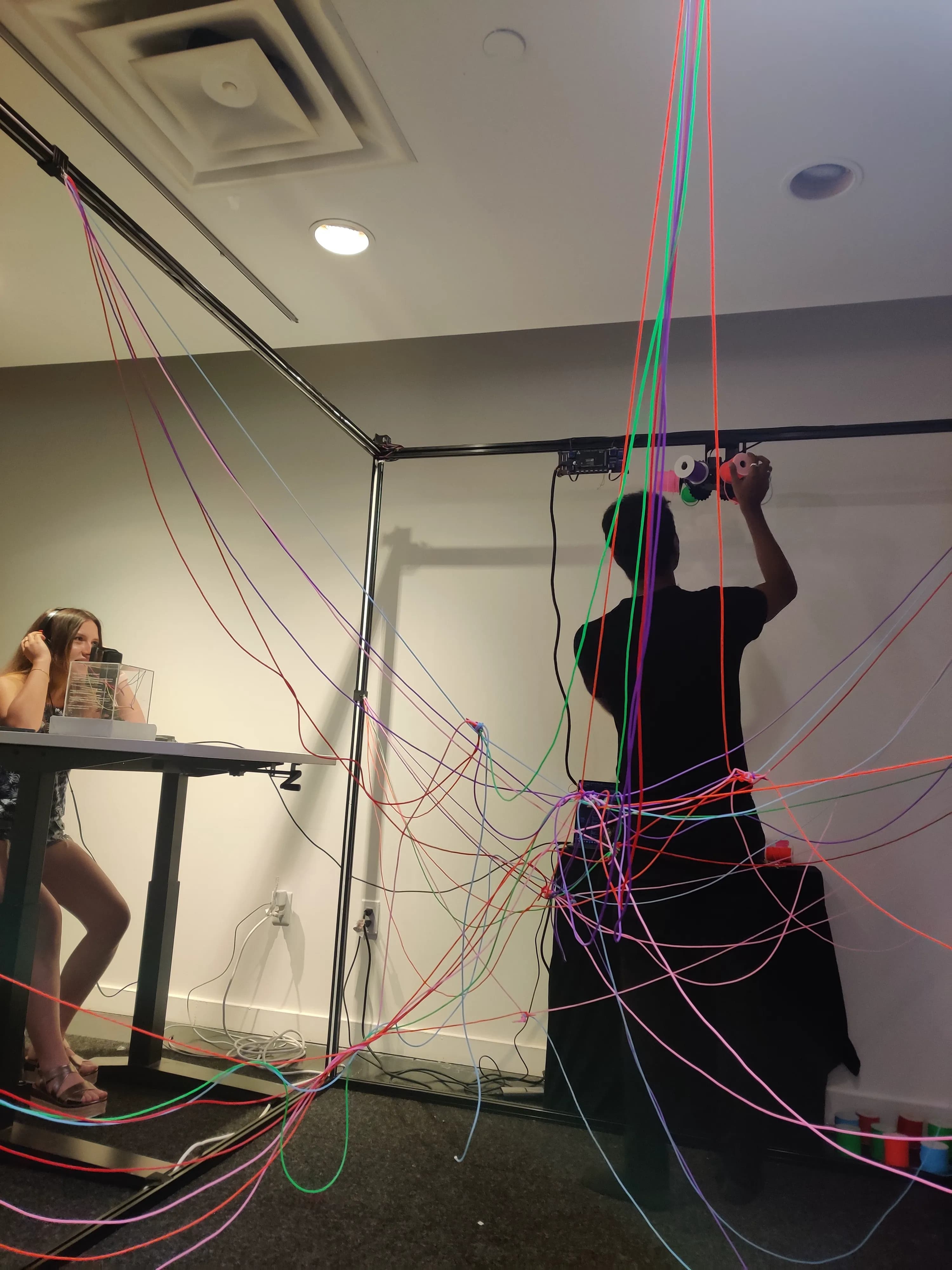 The dense web of colorful threads filling the installation frame after many conversations