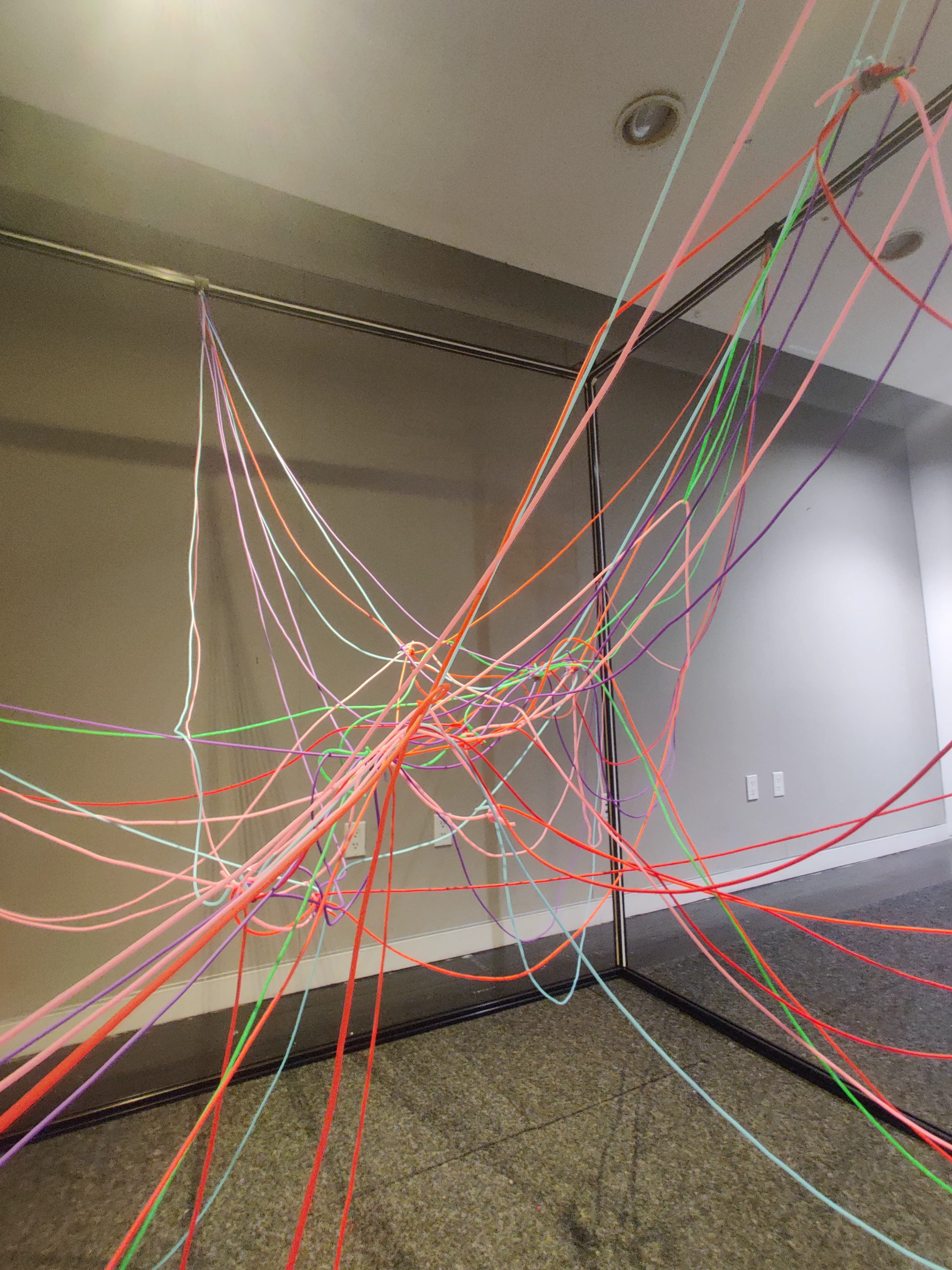 Gallery view showing the exhibition label and visitors exploring the installation at Parsons